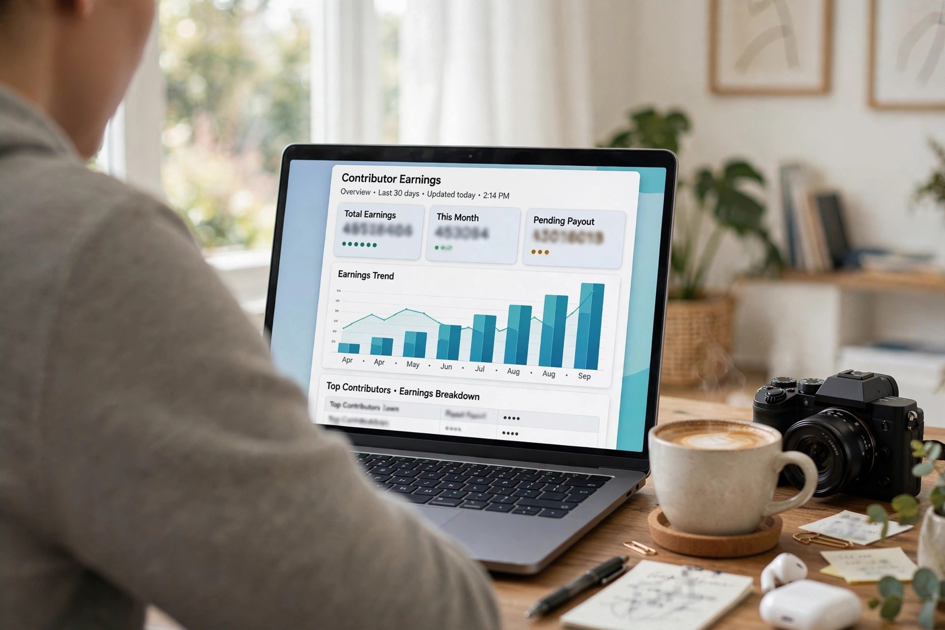 Laptop screen showing a generic contributor earnings dashboard with payout charts